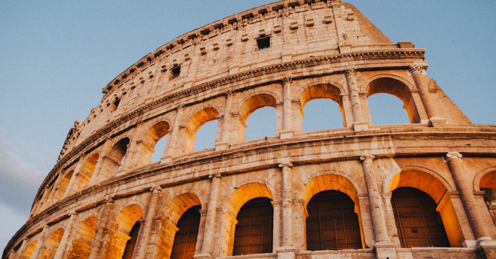 A stunning view of the Colosseum in Rome during sunset, showcasing ancient Roman architecture.